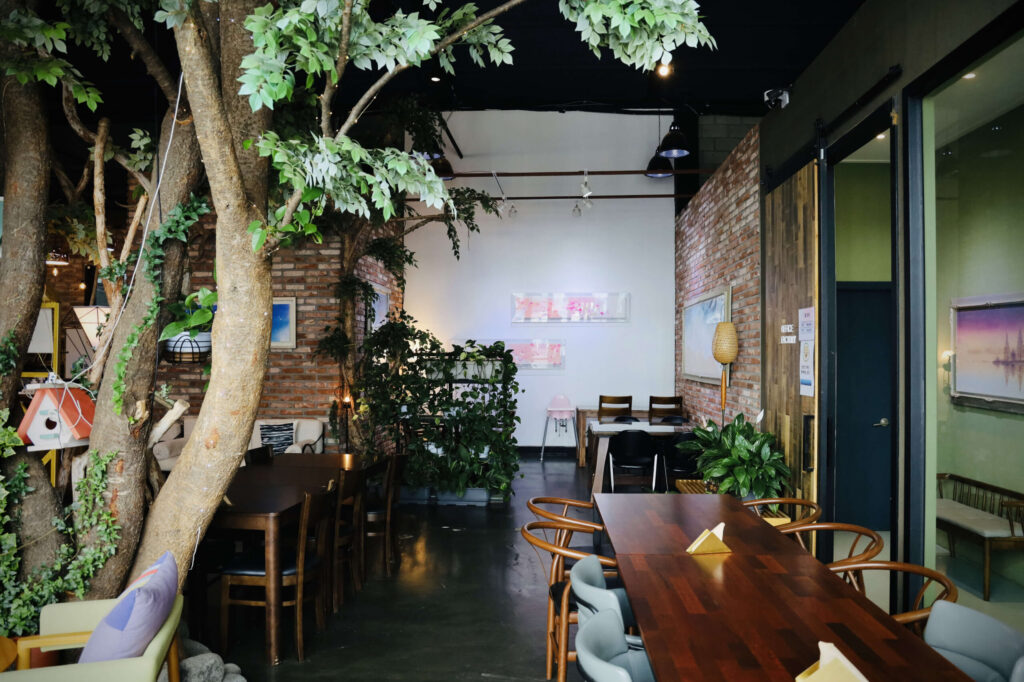 식물과 테이블이 어우러져 있는 반려동물 동반 카페 릴869의 실내 모습